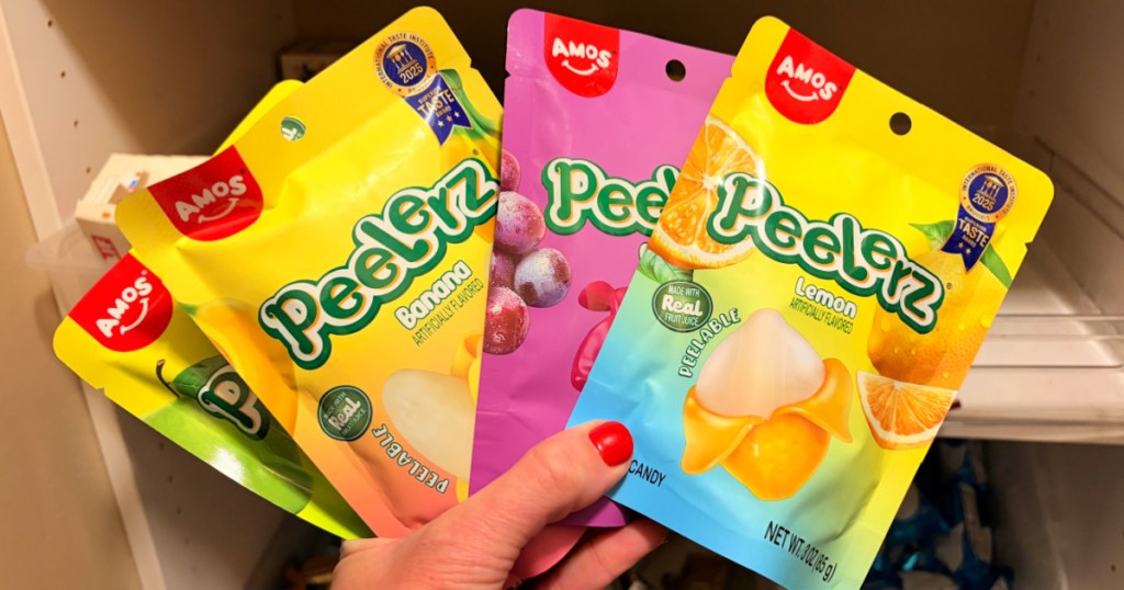 Hand holding up peelerz fruit, flavored peelable candy