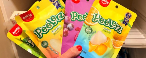 Hand holding up peelerz fruit, flavored peelable candy