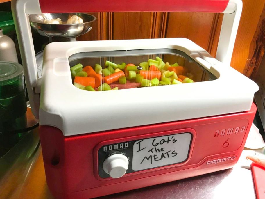 A presto nomad slow cooker filled with pot roast