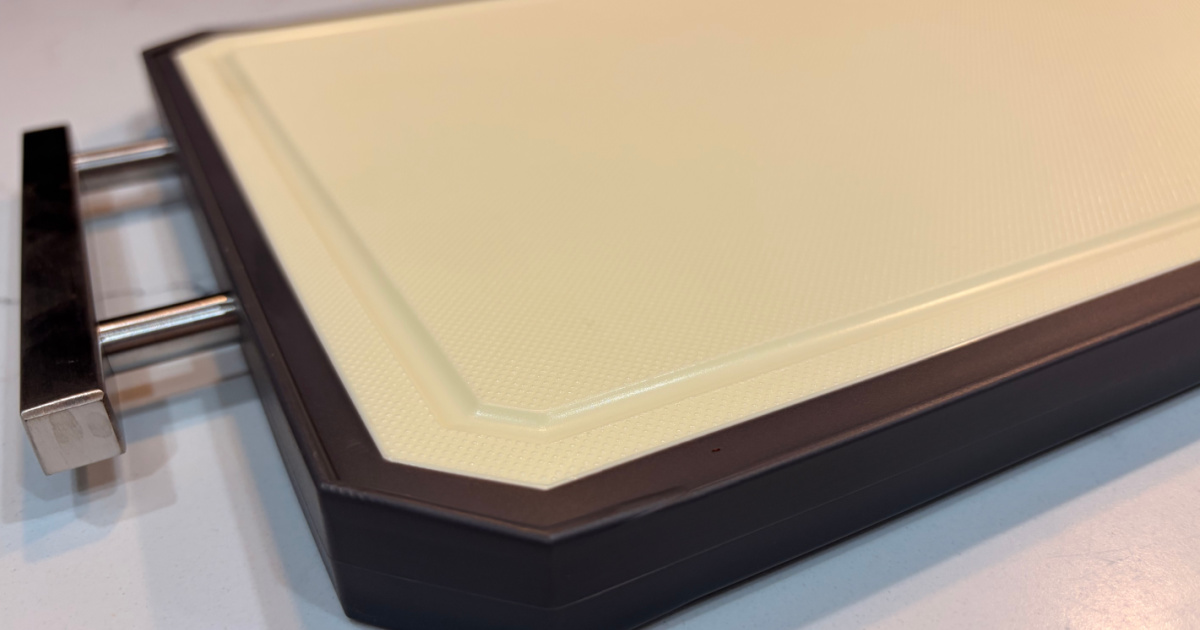Cutting board on white countertop with plastic side facing up