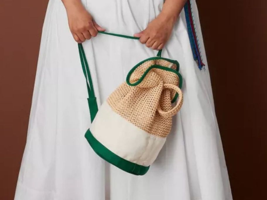 woman holding Rosie Assoulin x Target Bucket Bag