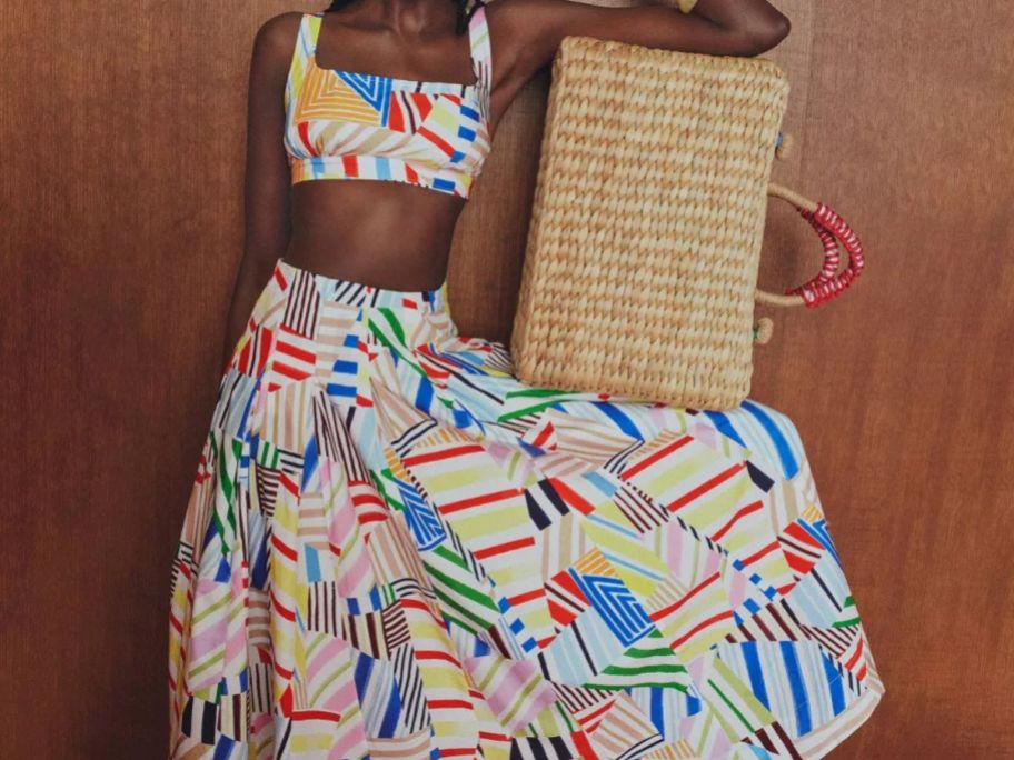woman wearing Rosie Assoulin x Target Women's Sleeveless Poplin Madras Bralette Top and Pleated Poplin Madras Midi Skirt