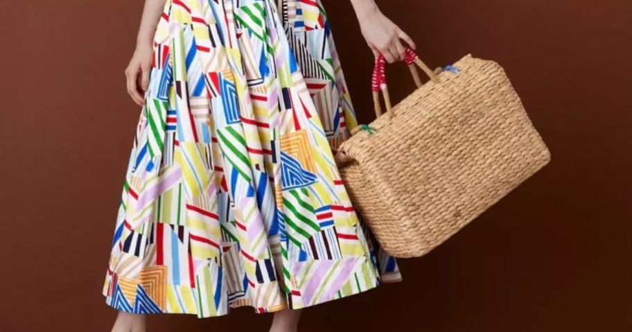 woman wearing Rosie Assoulin x Target dress while holding tote