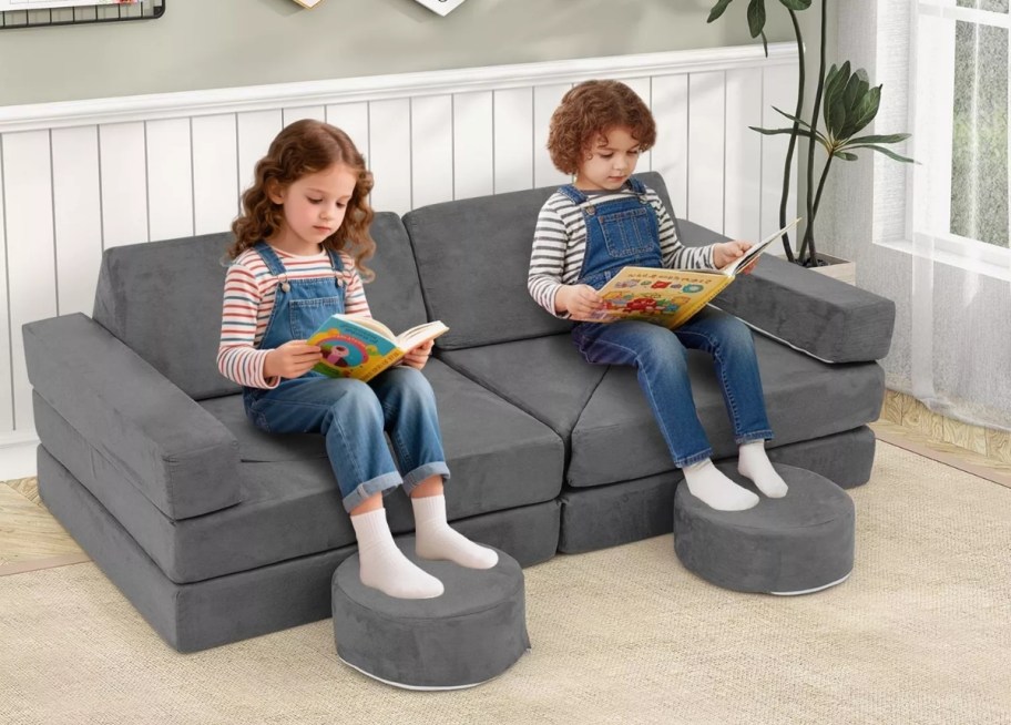 2 kids sitting on a play couch