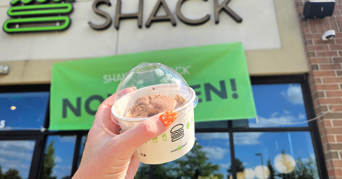 Handholding shake shack, custard while standing outside restaurant