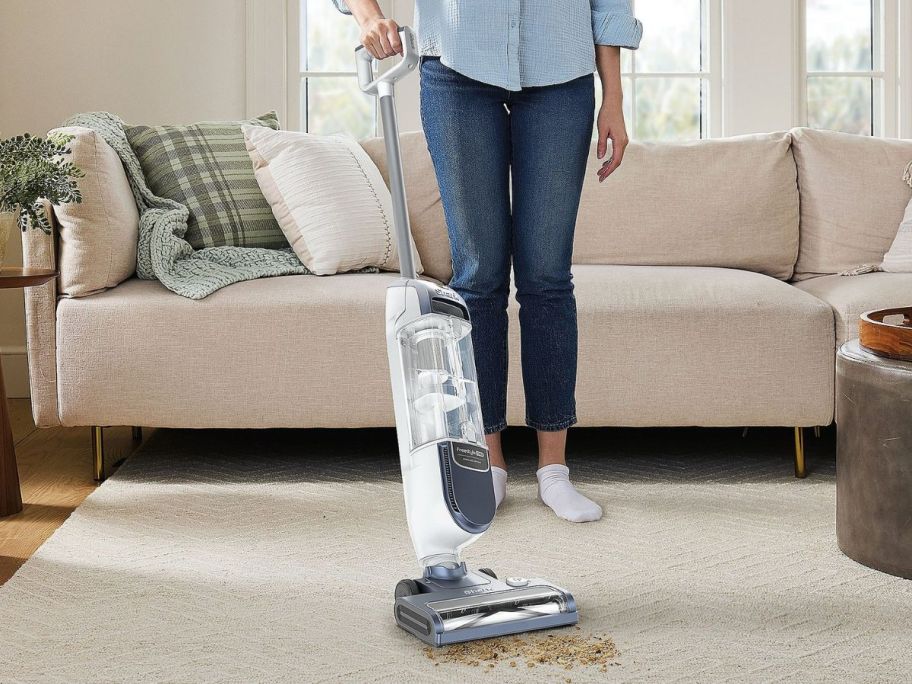 person using Shark FreeStyle Max Cordless Upright Vacuum