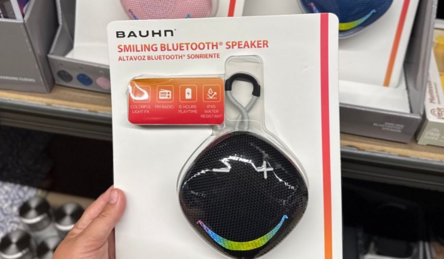 Hand holding black smiling speaker
