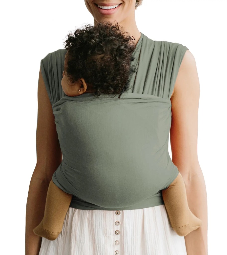 woman holding baby in green wrap