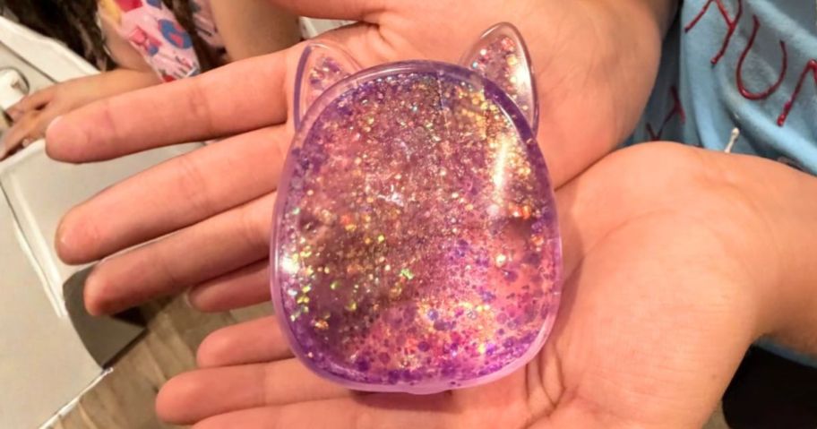 hand holding purple Squishmallows SlimyGloop Gelli Gel