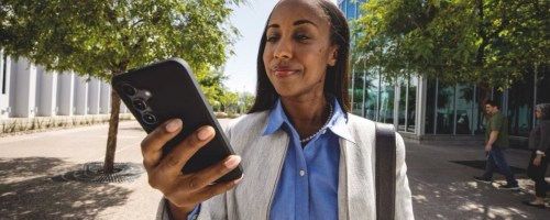 woman walking around outside holding cell phone
