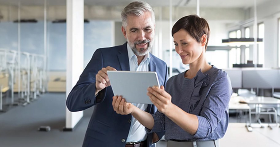 man and woman looking at a tablet