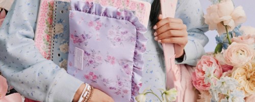 teenage girl holding Target LoveShackFancy school supplies
