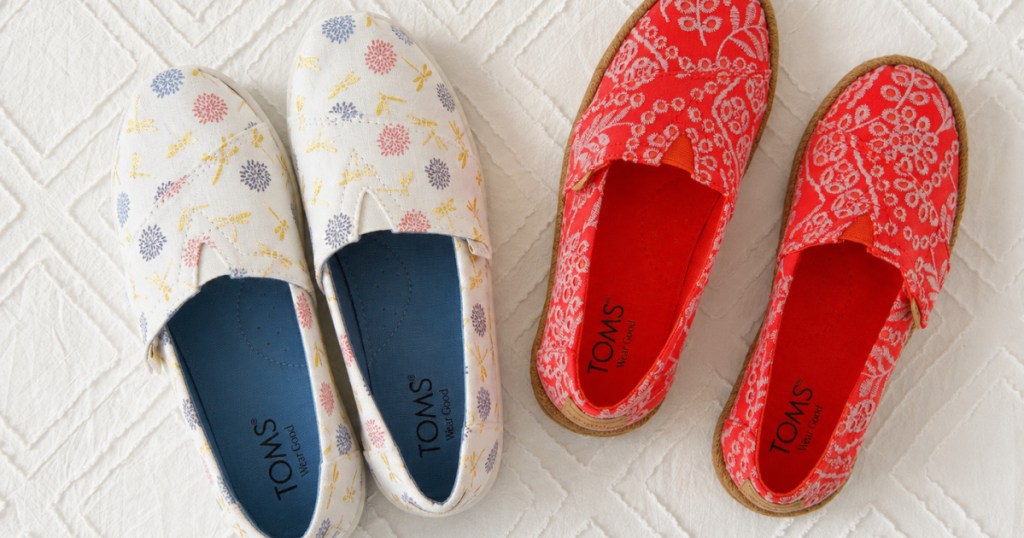 Two pairs of Tom shoes on white carpet