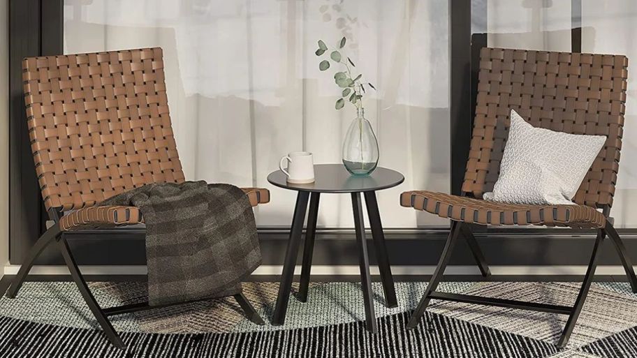 Two outdoor seating chairs with side table in-between them
