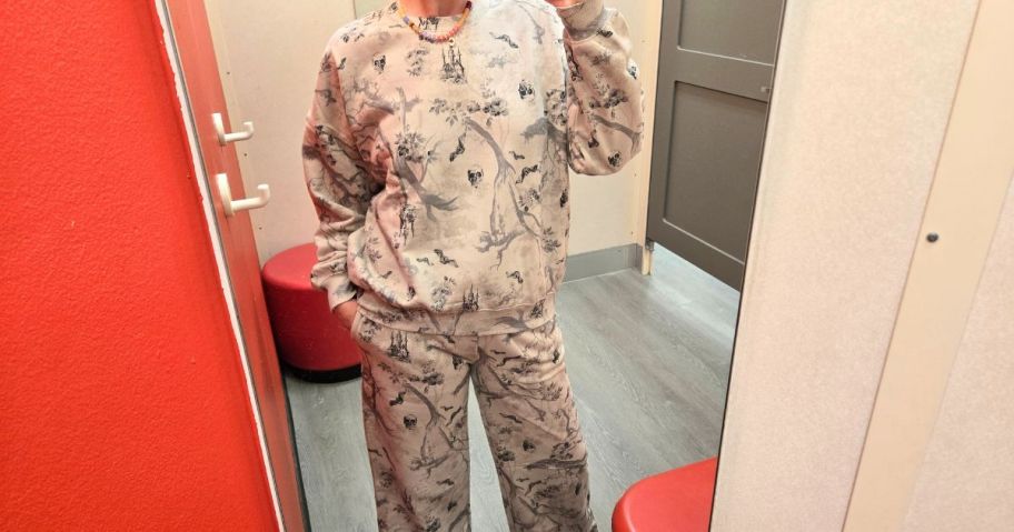 stefanie wearing Vinyl Threads Women's Crewneck Woodsy Halloween Graphic Pullover Sweatshirt and pants in store dressing room