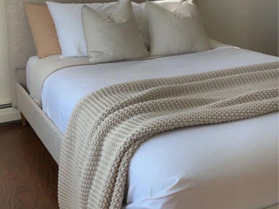 A bed made with white wayfair sheets