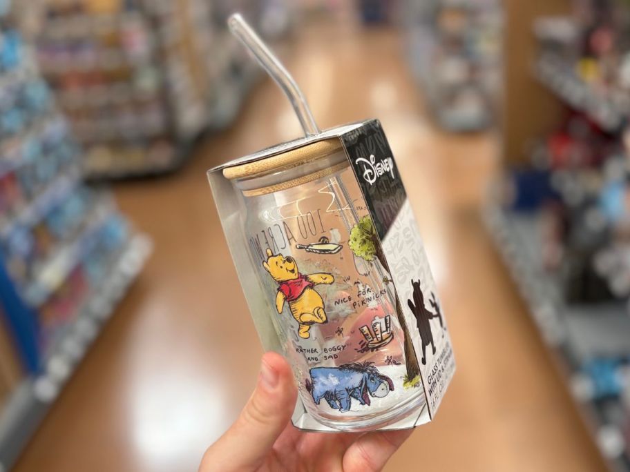 Hand holding a winnie the pooh glass sipper