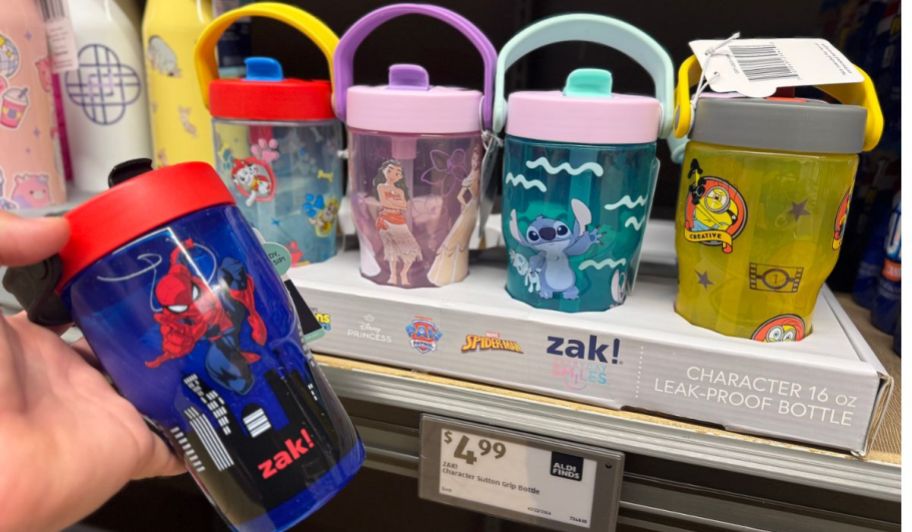 hand holding spiderman Zak! character leak proof bottle next to other tumbers
