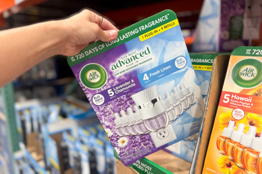 hand grabbing plug in warmer pack off shelf