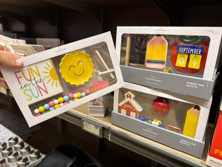 sets of decorative items in boxes in a store aisle