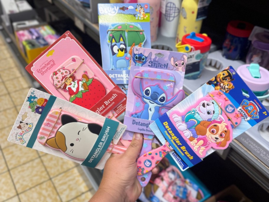 hand holding character hair brushes
