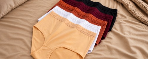 five pairs of women's underwear on a bed