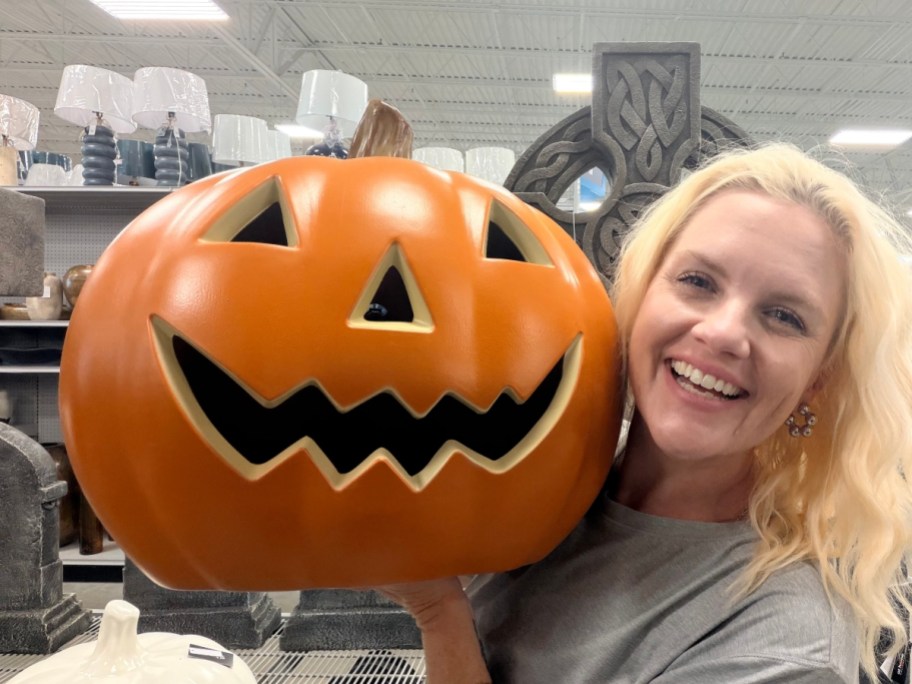 woman holding jack-o-lantern blow mold