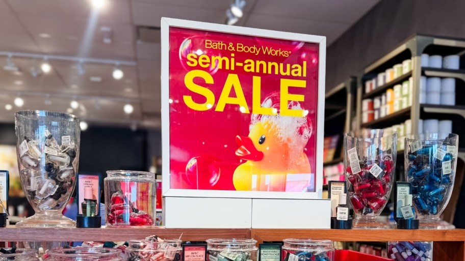 bath & body works semi annual sale signage on a store display table