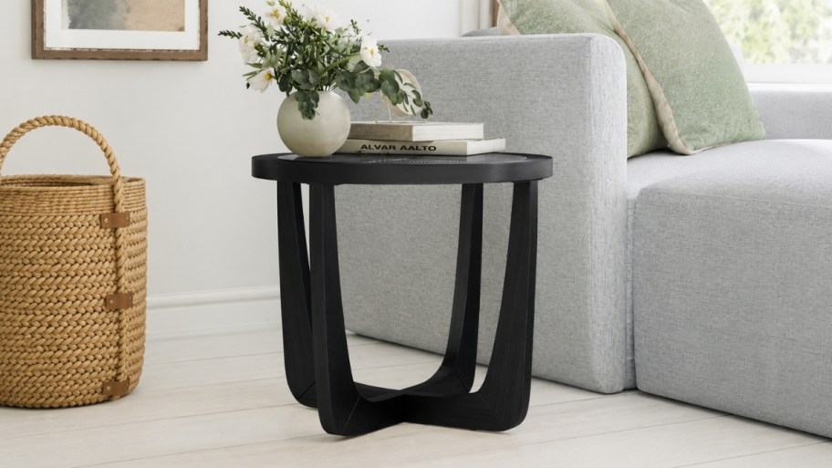 a black wood endtable with glass top