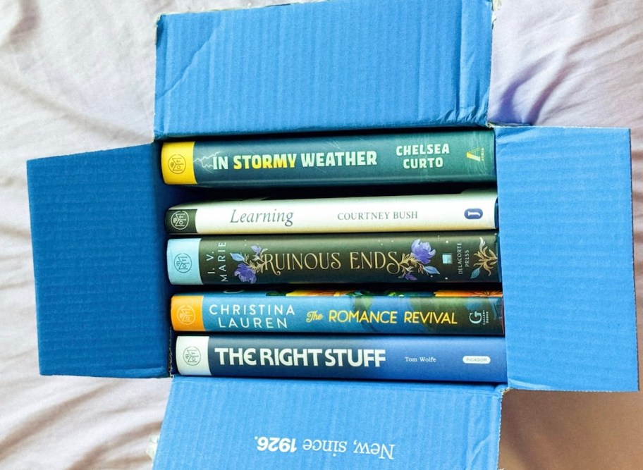 open blue box with hardcover books inside