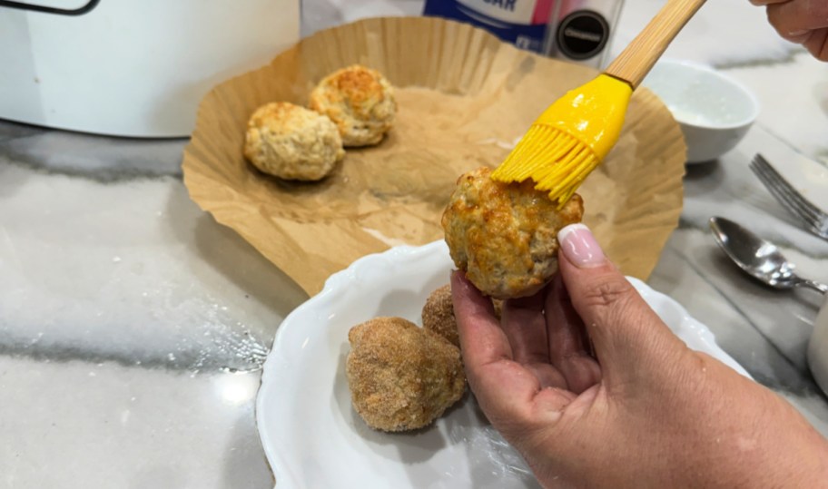 brushing donut holes with coconut oil