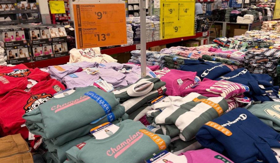 Sams club display of champion kids clothing with the pricing breakdown on the back