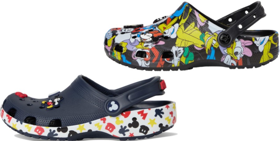 A pair of Disney-themed Crocs featuring a navy blue pair with Mickey Mouse charms and a patterned white sole, alongside a black pair with an all-over classic cartoon character print.