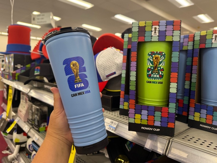 a hand holding a fifa tumbler cup