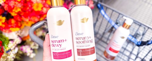 hand holding dove serum+ oil body wash bottles over cart