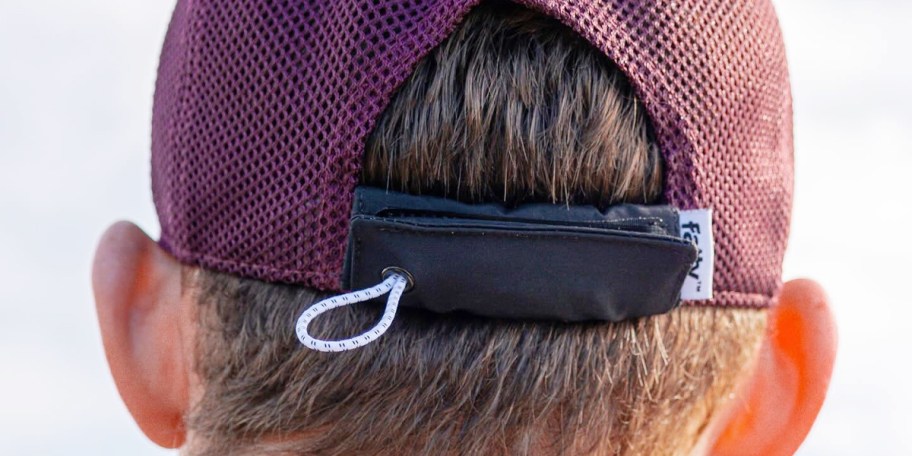 person wearing purple hat with fattypack wrapped around it 