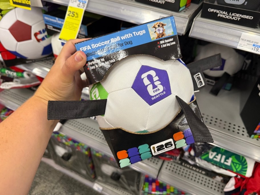 a hand holding a tug toy soccer ball