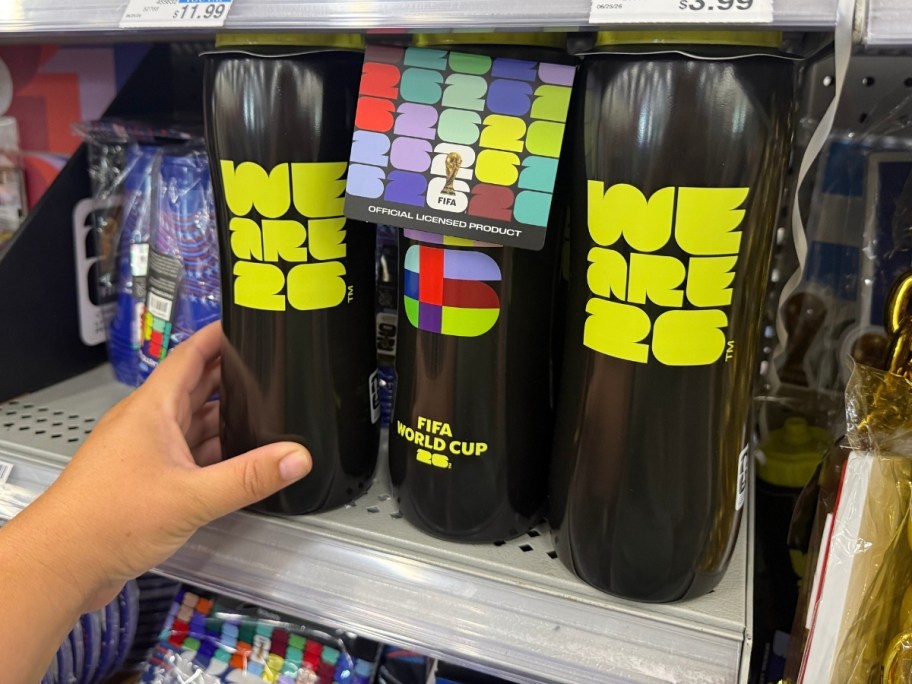a hand reaching for a water bottle