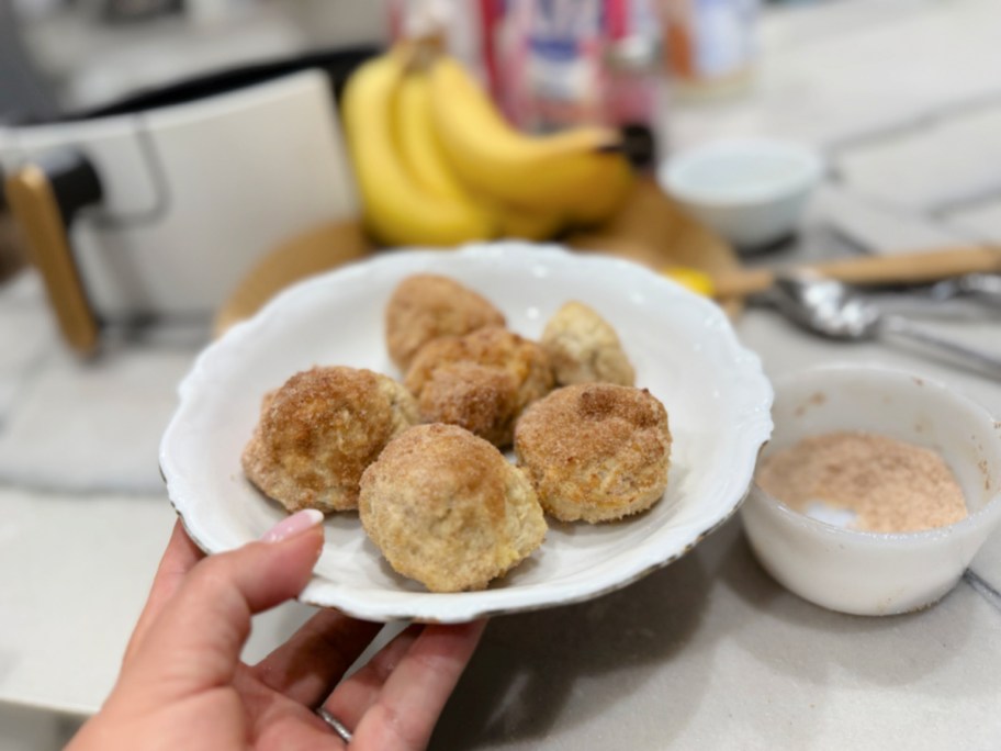 finished donut holes on a plate with cinnamon and sugar