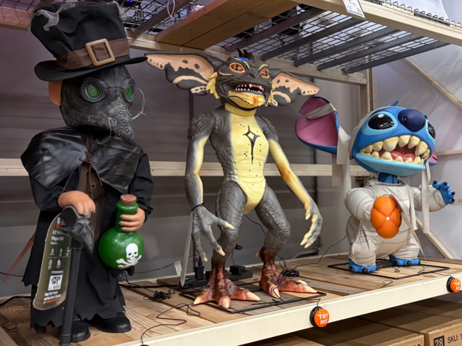 plague rat, gremlin, and stitch animatronic on shelf