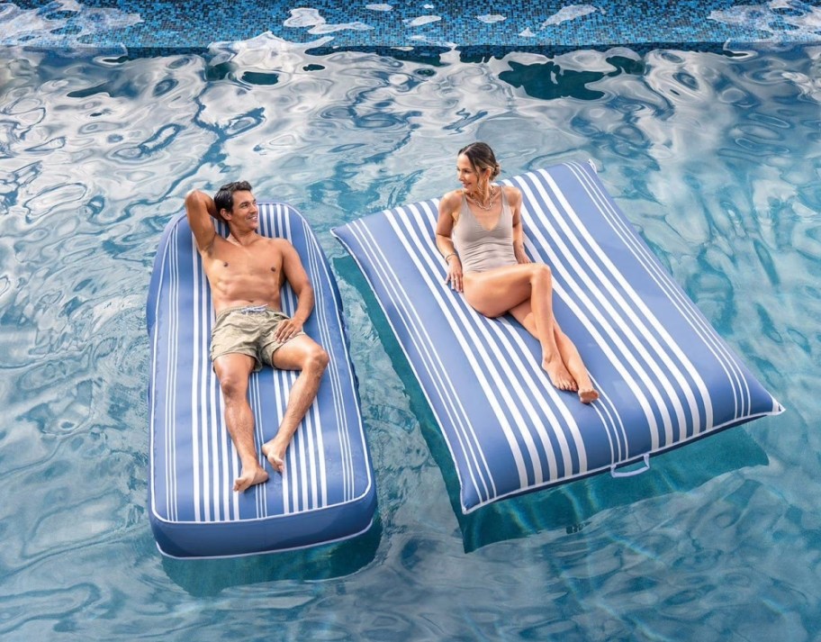two people on pool floats in a pool