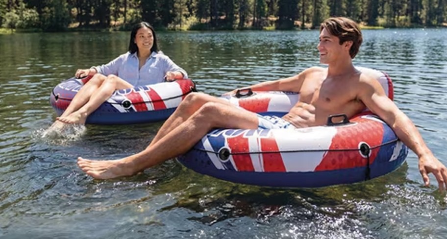 people floating in floats on river 