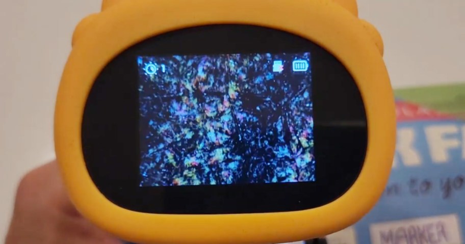 child holding a microscope