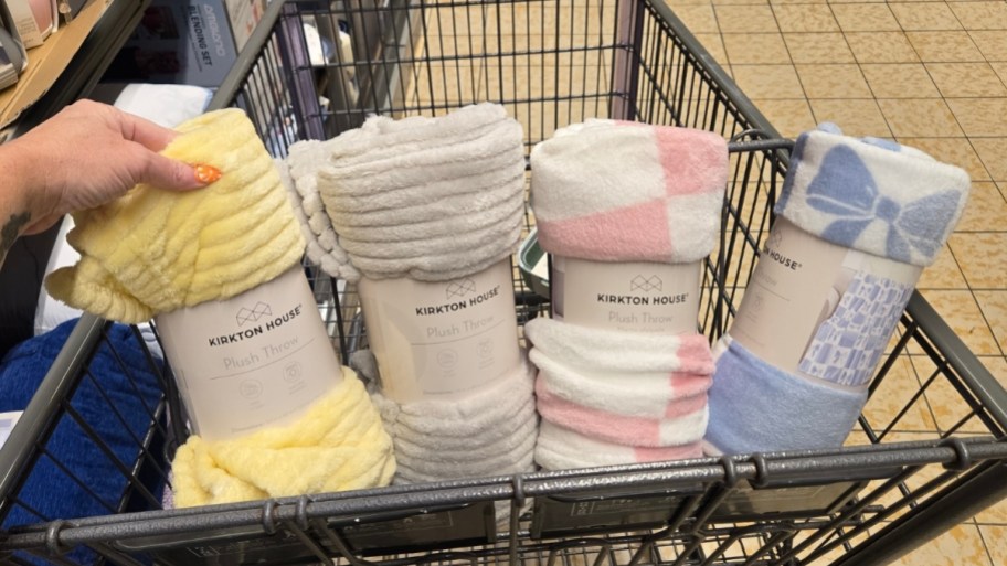 four throw blankets in a shopping cart