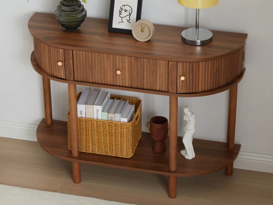 wood side table with lamps and decor on top 