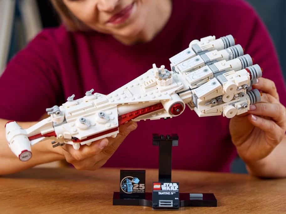 teen building lego star wars ship set 