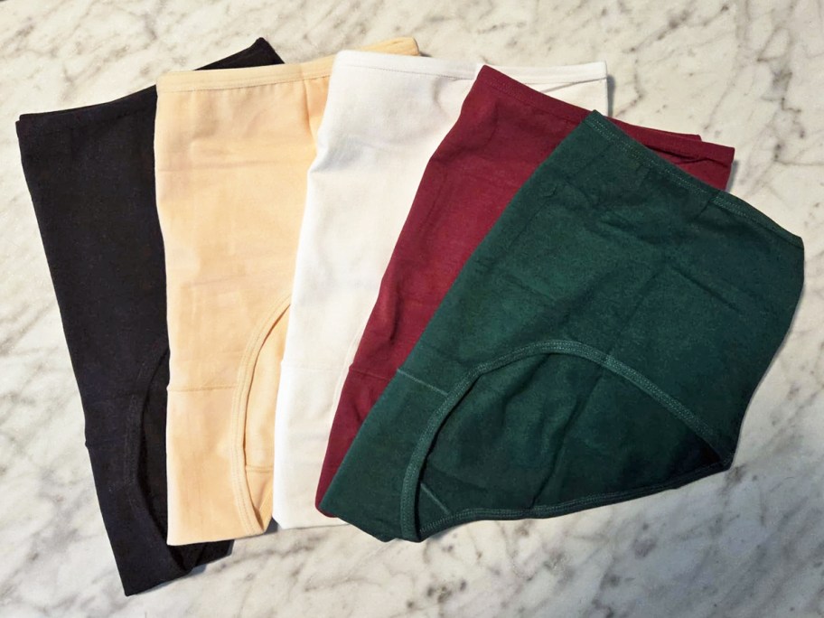 pairs of cotton underwear in various colors stacked on one another