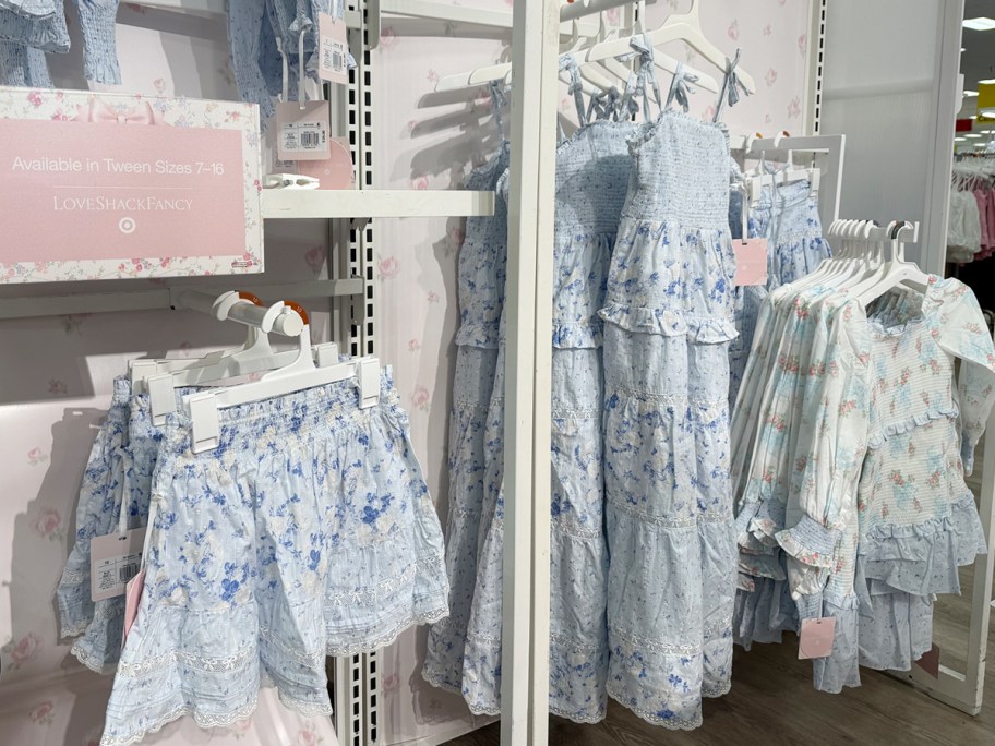 blue floral skit and dresses hanging in store 