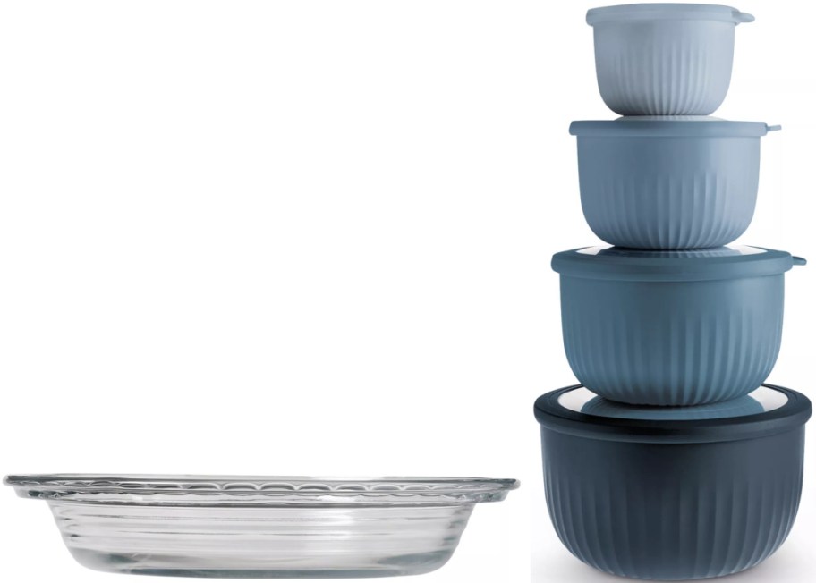 A glass pie dish on the left and a stacked set of four blue ribbed mixing bowls with lids on the right.
