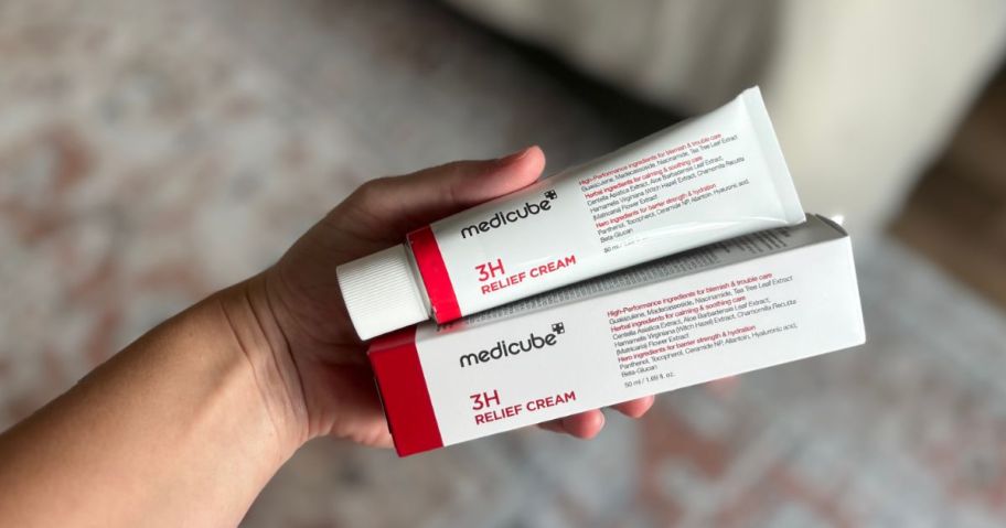 hand holding medicube 3H cream tube and box